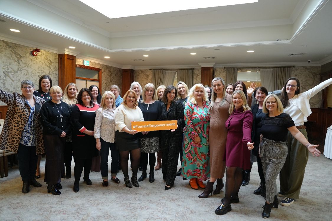 Group of women, cheering, with sign #femaleempowerment